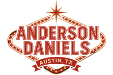 Neon sign of Anderson Daniels with decorative elements on a black background